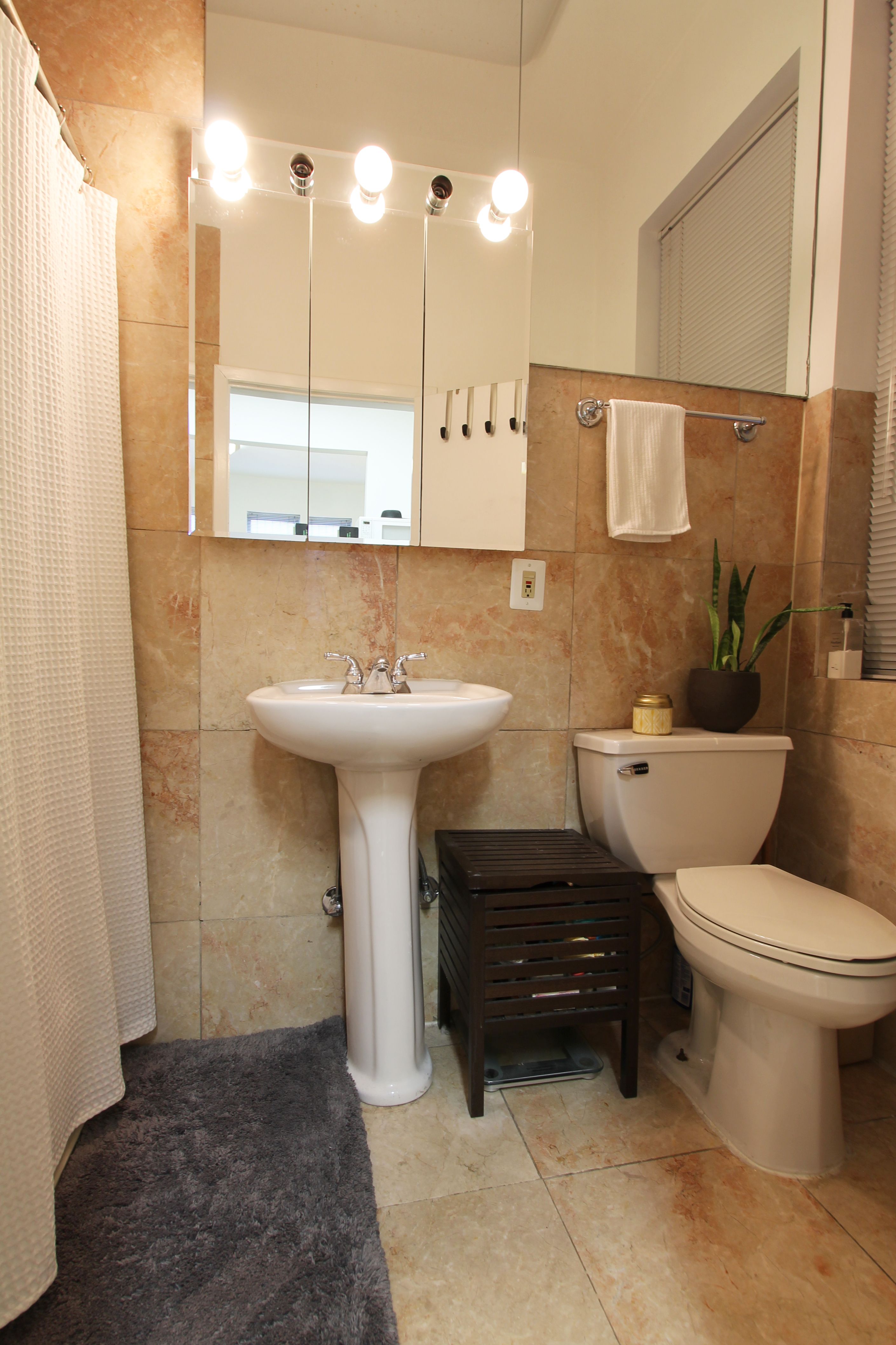 1313 3rd Avenue, Unit 2RS Manhattan, NY 10021 - Photo 4 of 4 a bathroom with a sink a toilet and a mirror