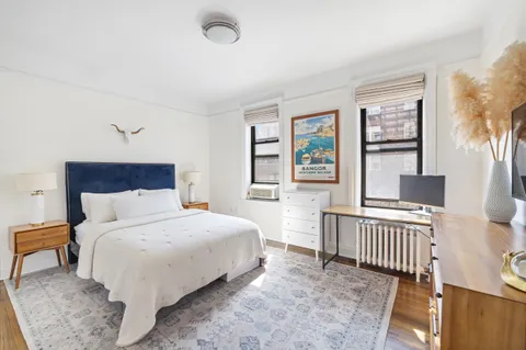 a bedroom with a bed and a large window