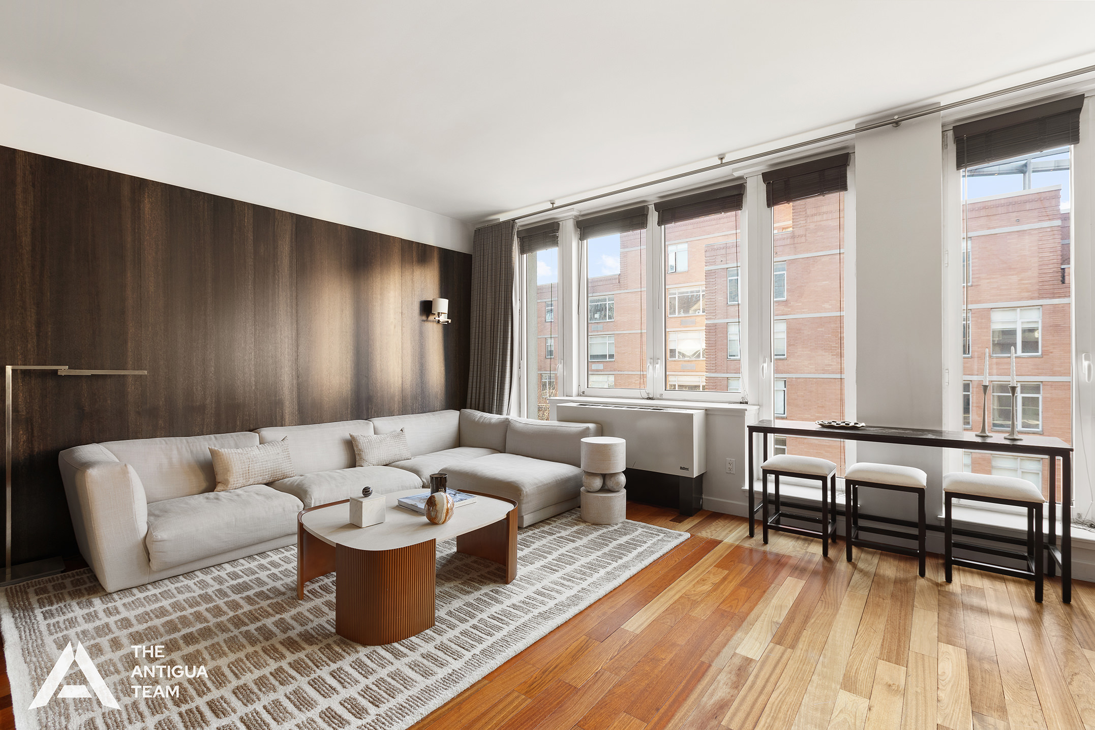 125 West 21st Street, Unit 12A Manhattan, NY 10011 - Photo 2 of 16 a living room with furniture and a table