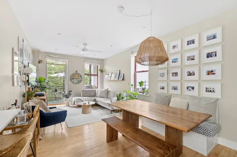 a living room with furniture a table and decor