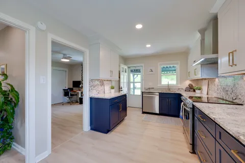 a stove top oven sitting inside of a kitchen