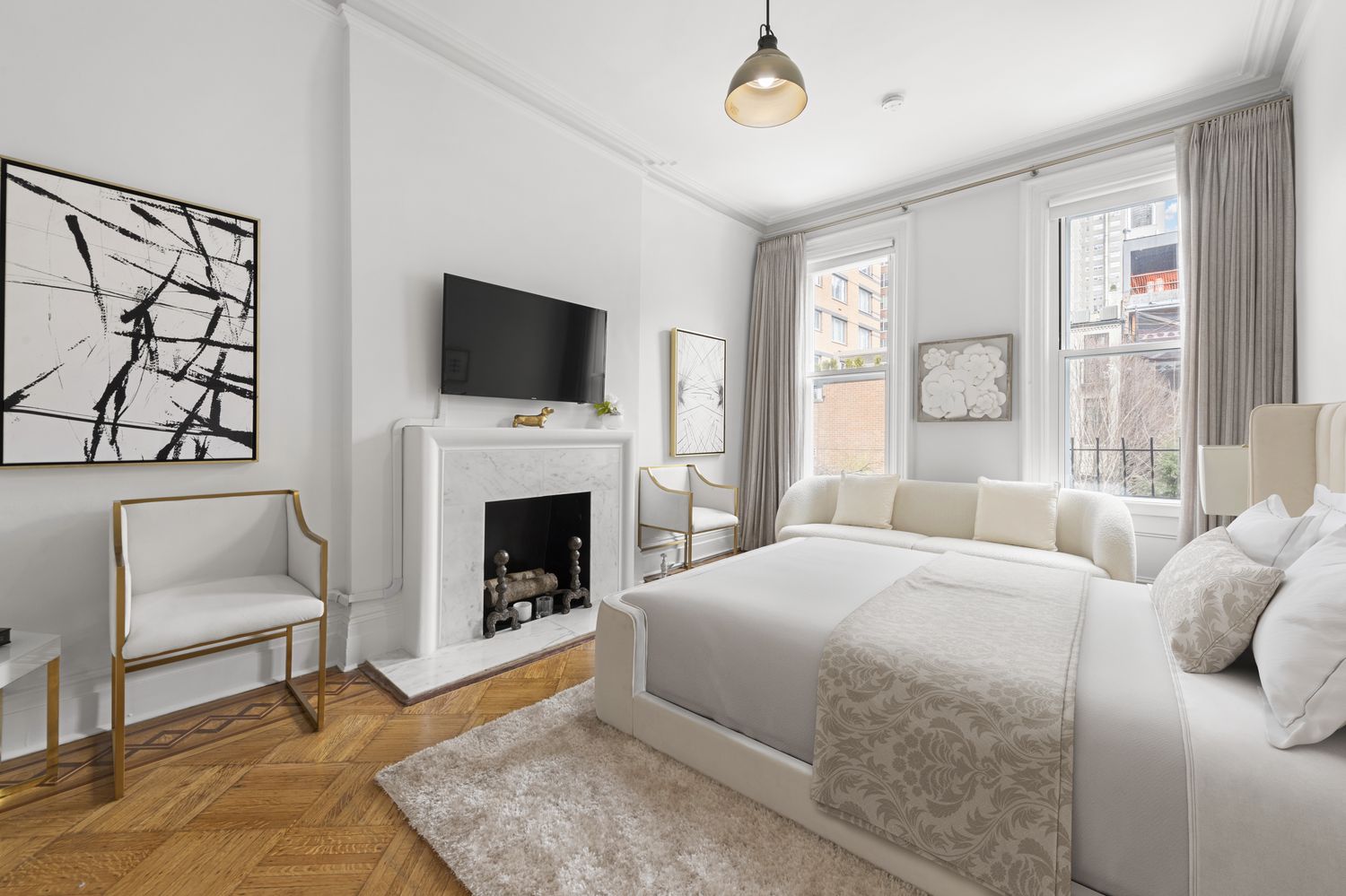 209 East 61st Street Manhattan, NY 10065 - Photo 12 of 24 a bedroom with a large bed and a fireplace