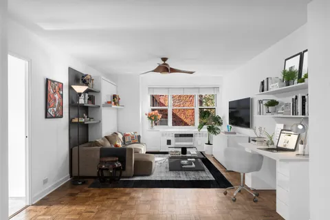 a room with furniture a flat screen tv and a table