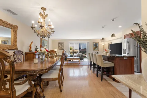 a view of a dining room with furniture and a chandelier