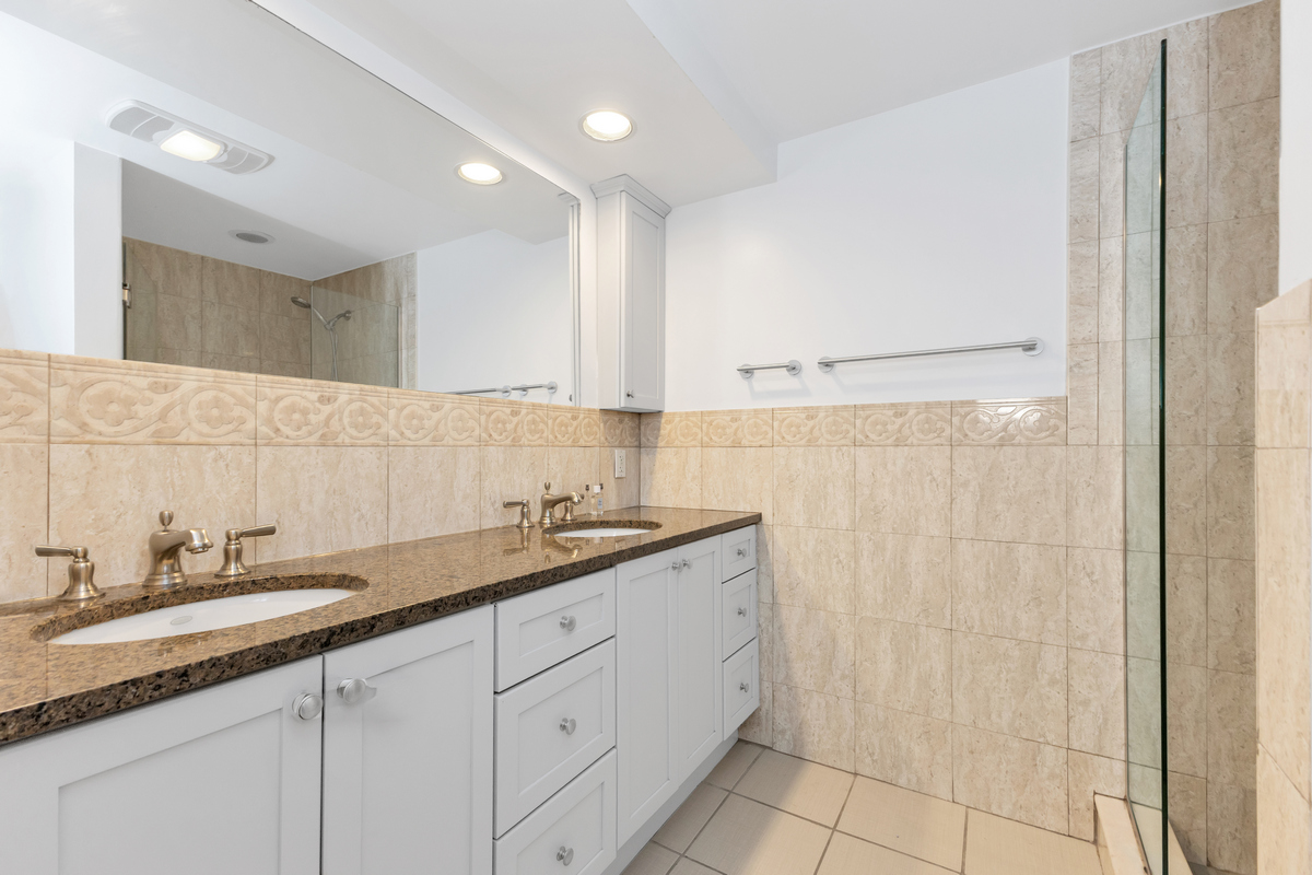 74 2nd Place, Unit 2B Brooklyn, NY 11231 - Photo 10 of 14 a bathroom with a granite countertop sink a mirror and a shower