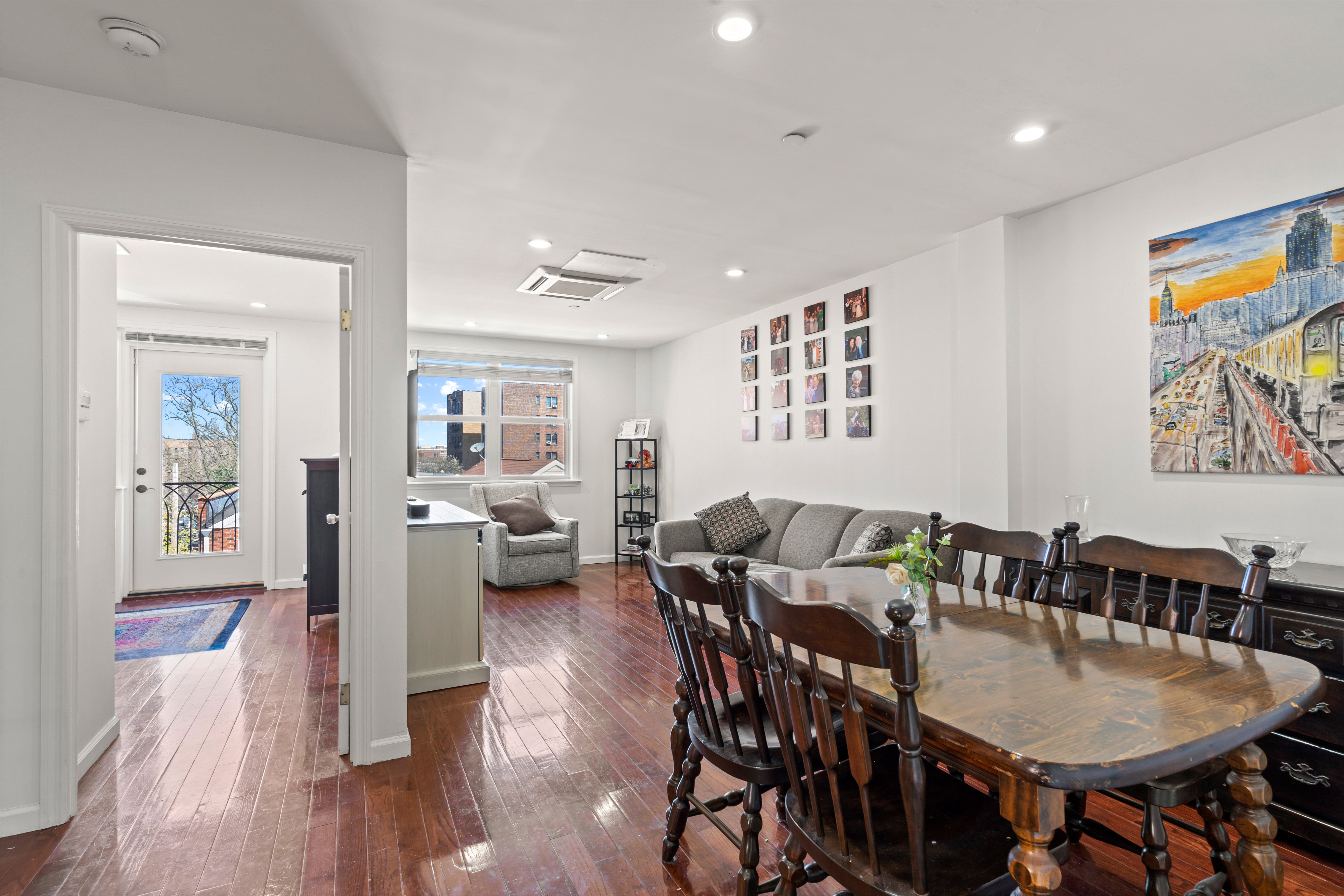 a view of a dining room with furniture and wooden floor