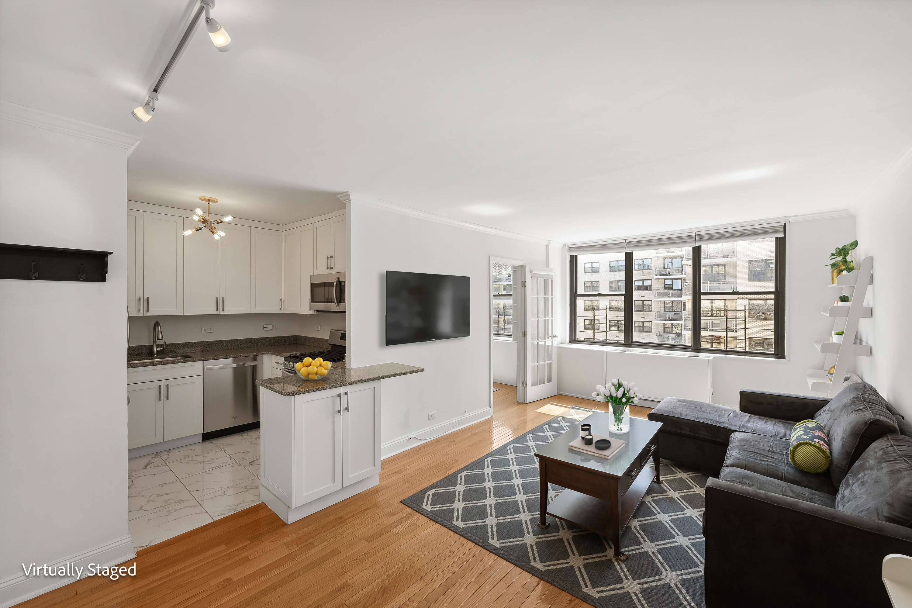 301 East 87th Street, Unit 16E Manhattan, NY 10128 - Photo 1 of 16 a living room with furniture and a flat screen tv