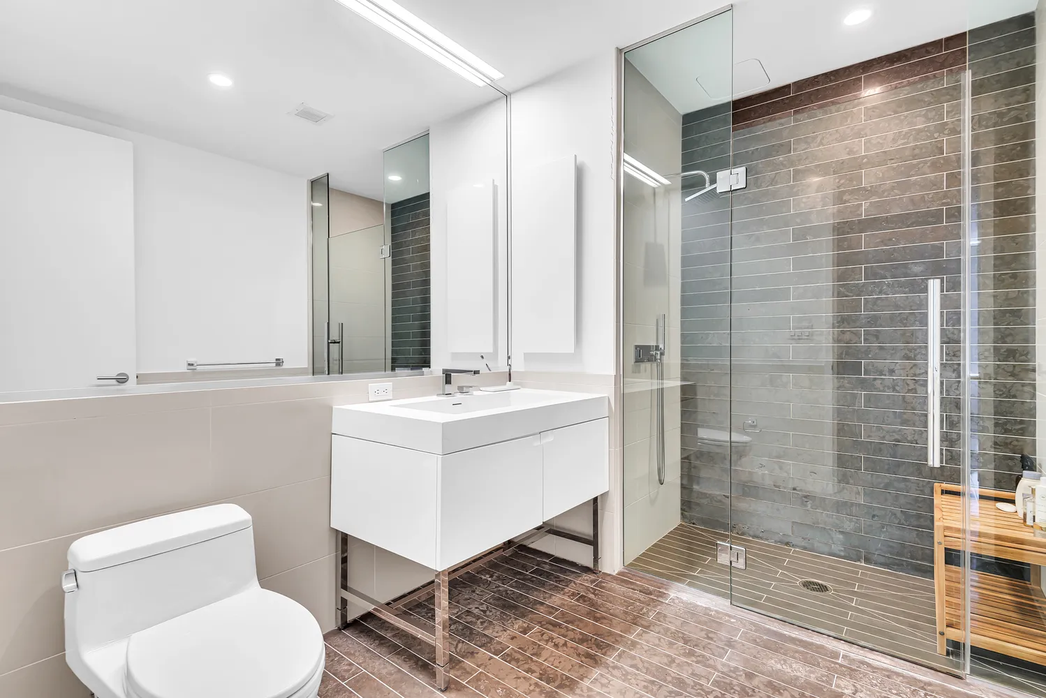 a bathroom with a toilet sink shower and mirror