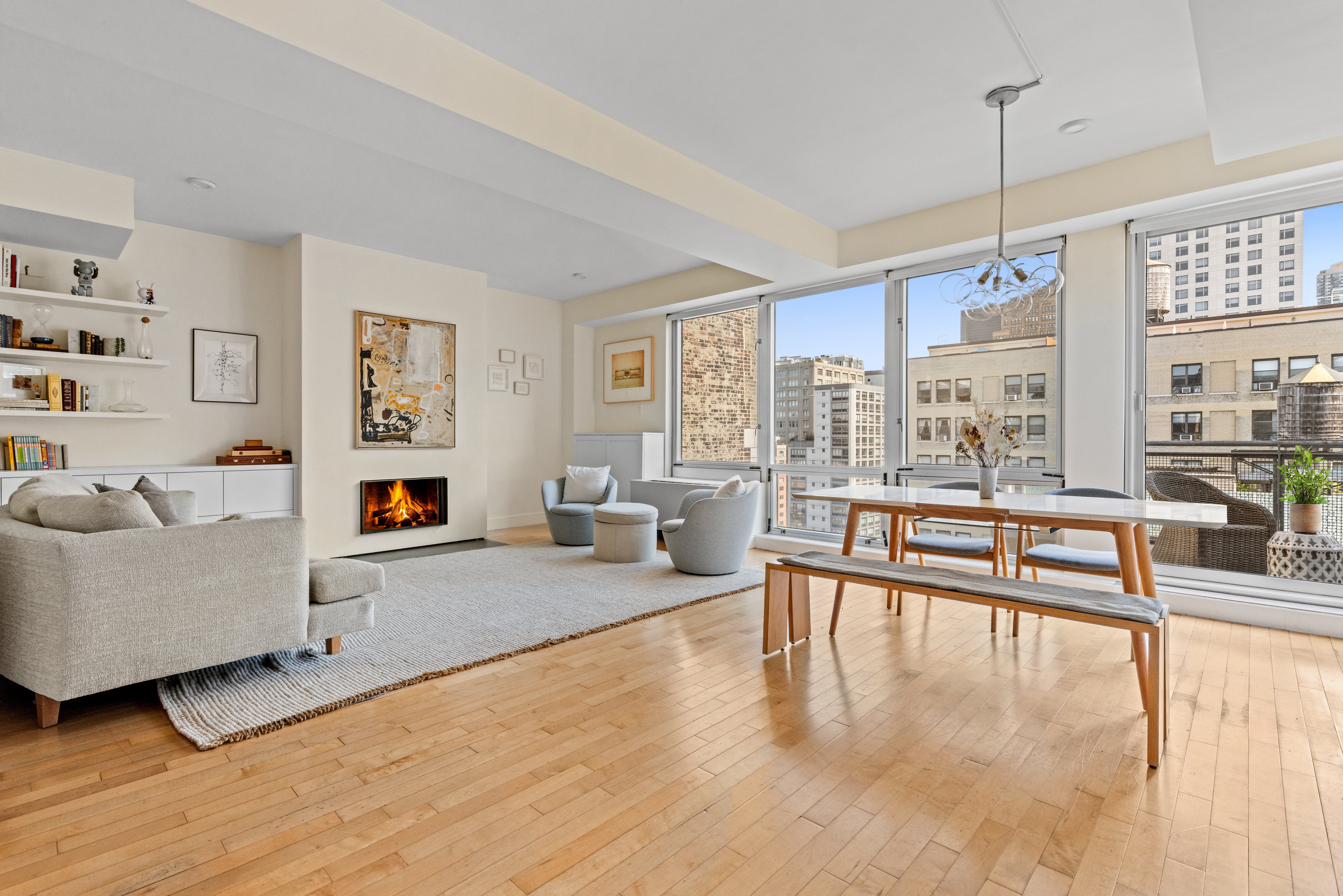 146-148 West 22nd Street, Unit PH Manhattan, NY 10011 - Photo 2 of 12 a living room with furniture and a floor to ceiling window