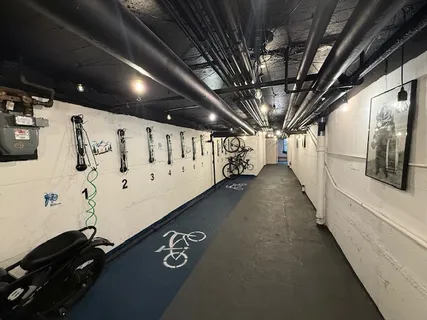 a view of a hallway with wooden ceiling fan