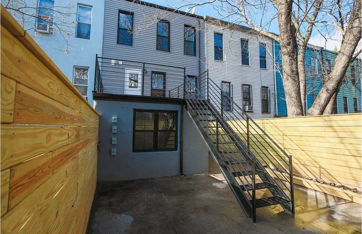 1128 Halsey Street, Unit 1 Brooklyn, NY 11207 - Photo 5 of 6 a view of a house with many windows