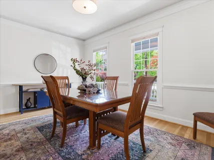 a living room with stainless steel appliances furniture a refrigerator and a flat screen tv
