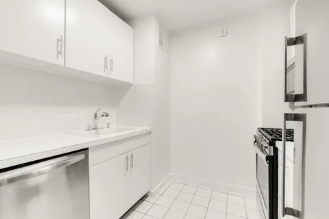 a utility room with cabinets washer and dryer