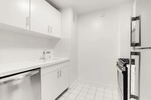 a utility room with cabinets washer and dryer