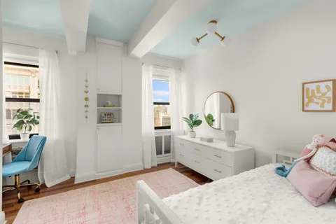 a bedroom with a bed and a desk