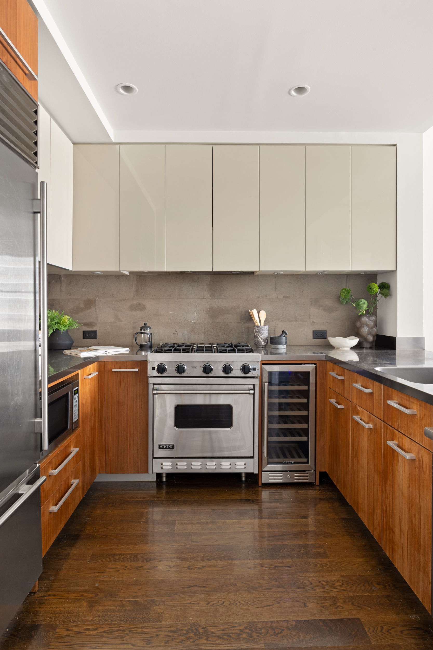 260 Park Avenue South, Unit 9G Manhattan, NY 10010 - Photo 6 of 17 a kitchen with granite countertop a stove cabinets and wooden floor