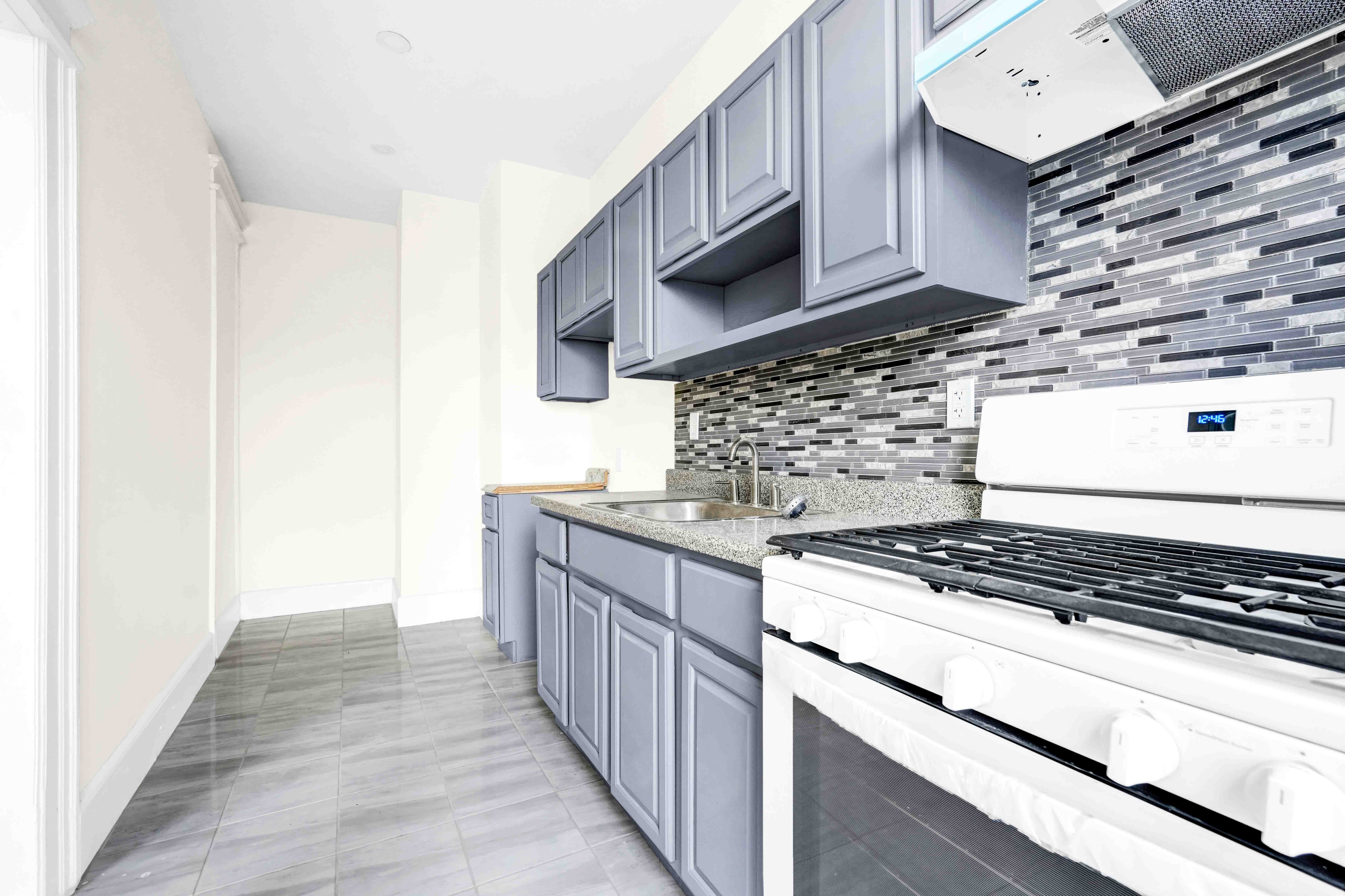 1770 Bedford Avenue Brooklyn, NY 11225 - Photo 36 of 50 a kitchen with stainless steel appliances granite countertop a stove and a microwave