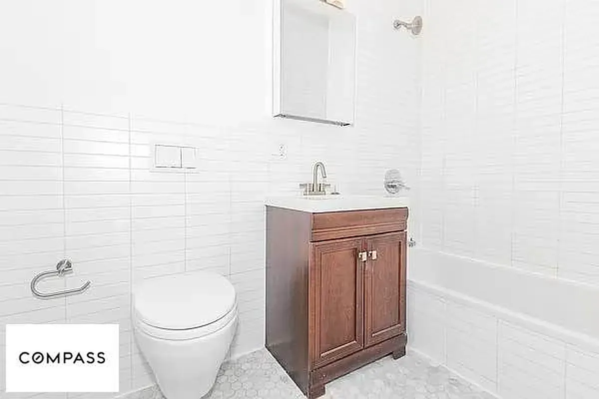 a bathroom with a toilet a sink a mirror and vanity