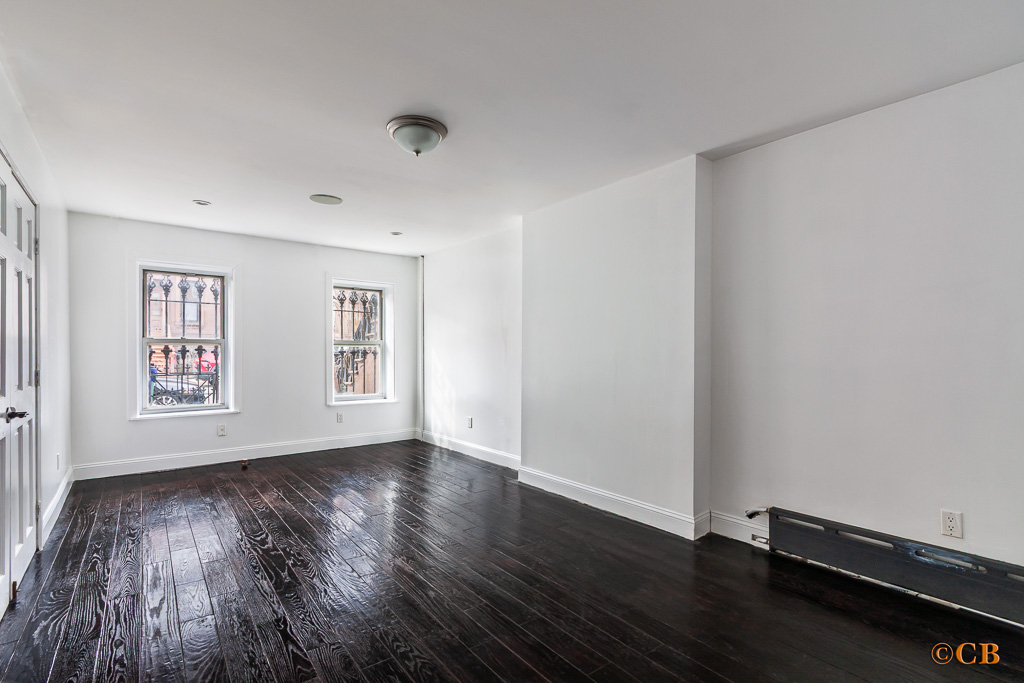 149 Van Buren Street, Unit GARDEN Brooklyn, NY 11221 - Photo 3 of 6 a view of an empty room with wooden floor and a window