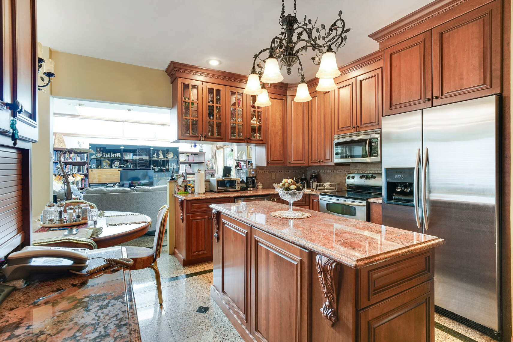 240 76th Street Brooklyn, NY 11209 - Photo 3 of 9 a kitchen with stainless steel appliances granite countertop a sink a stove and a refrigerator