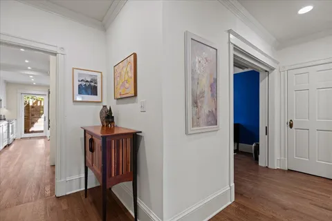 a living room with furniture a chandelier and a book shelf