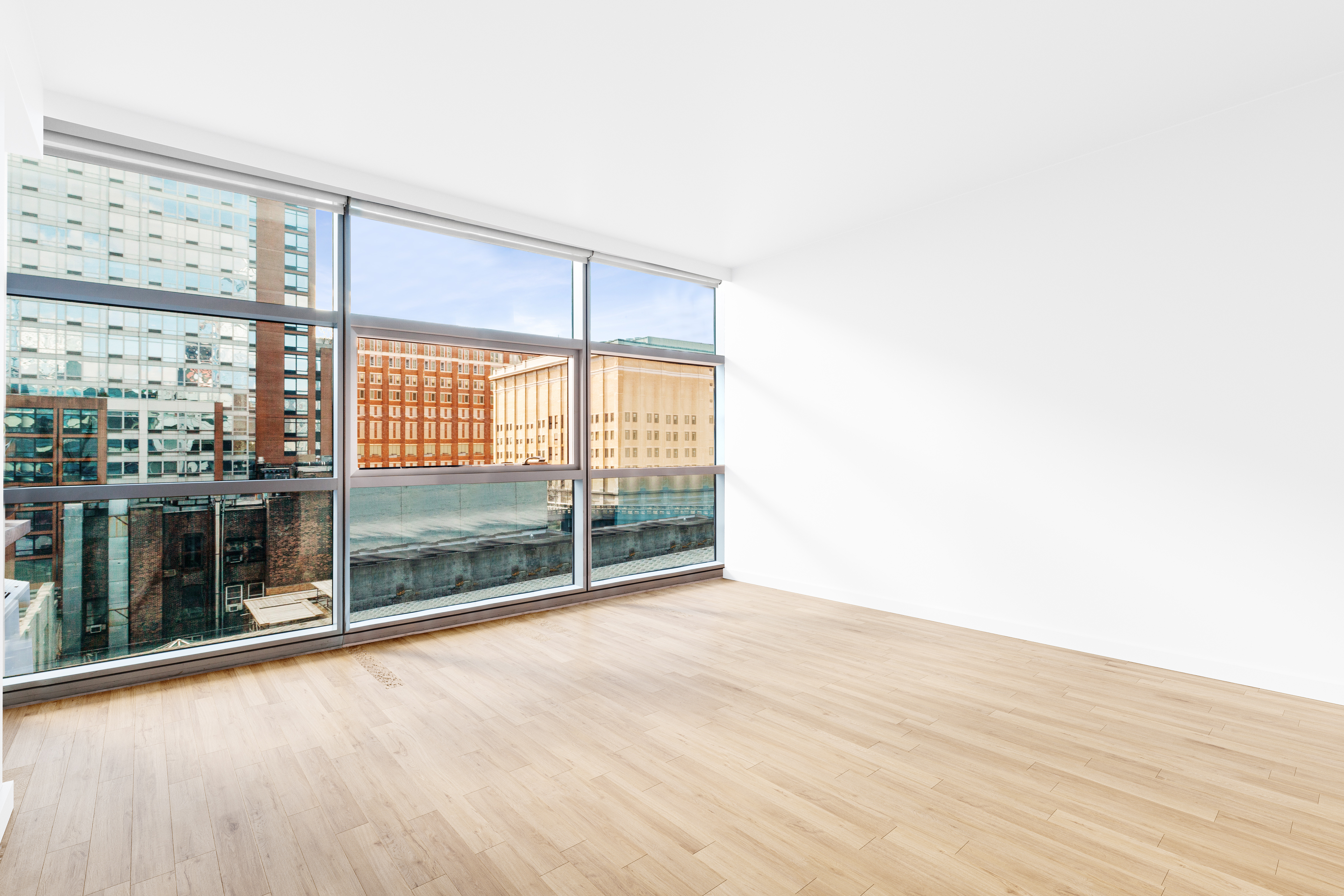 447 West 18th Street, Unit 7A Manhattan, NY 10011 - Photo 6 of 16 a view of an empty room with wooden floor and a window