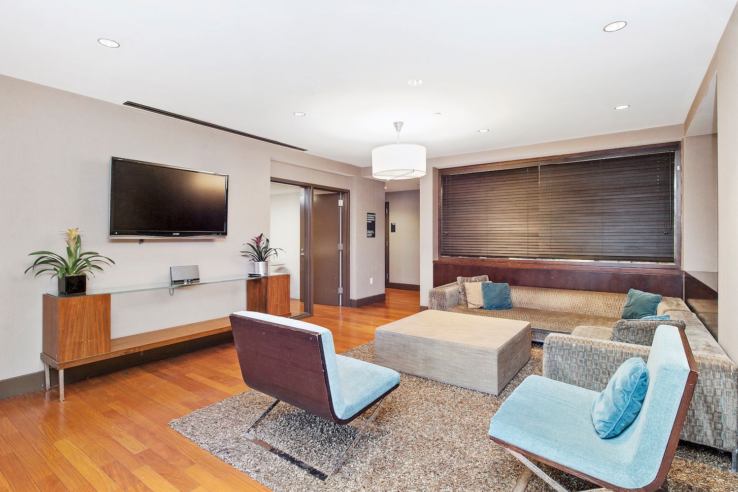 225 East 34th Street, Unit PHD Manhattan, NY 10016 - Photo 11 of 12 a living room with furniture and a flat screen tv