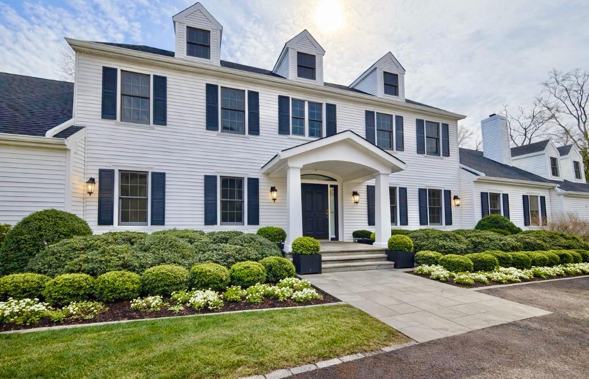a front view of a house with a garden