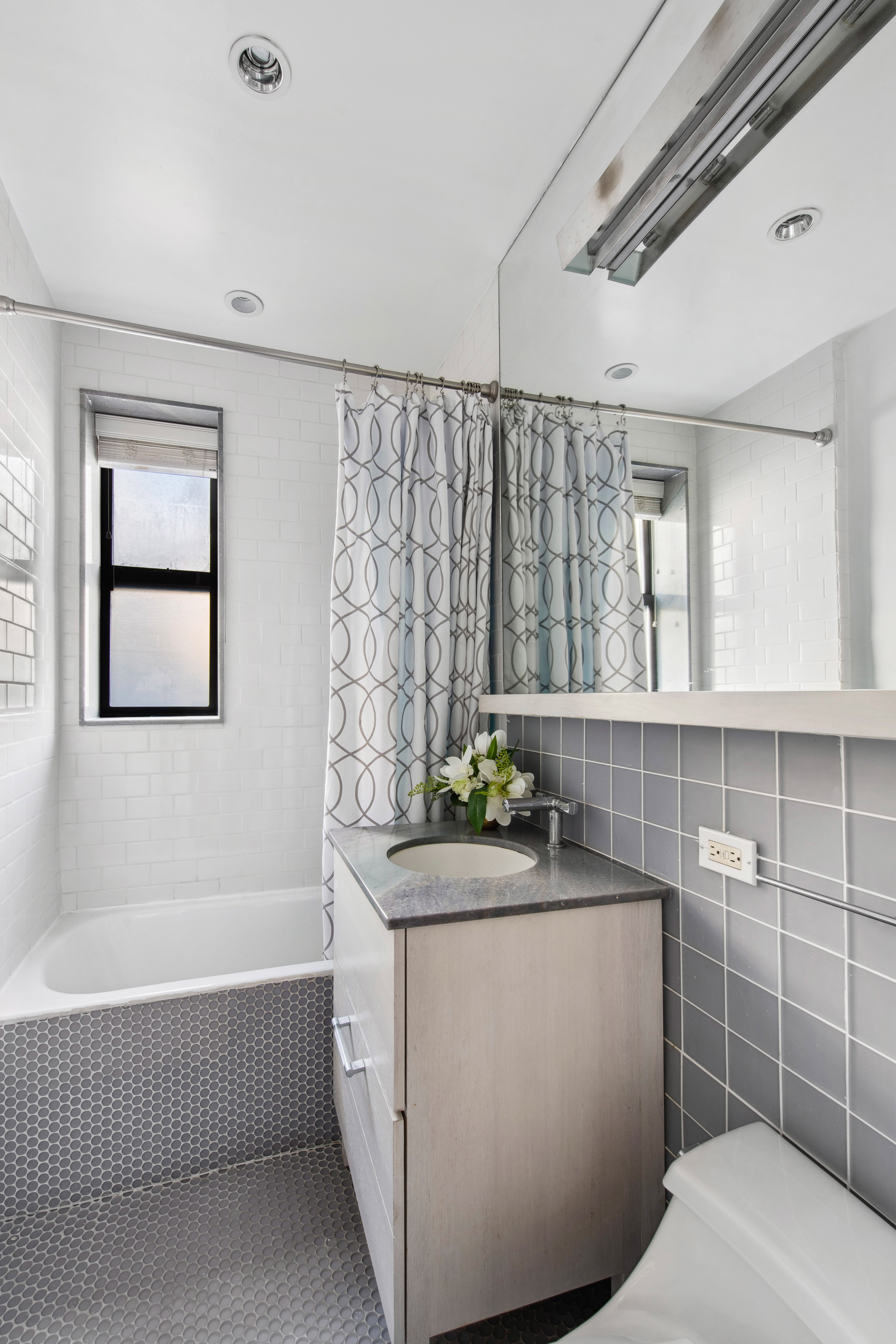 330 East 70th Street, Unit 5AB Manhattan, NY 10021 - Photo 10 of 13 a bathroom with a sink toilet and shower