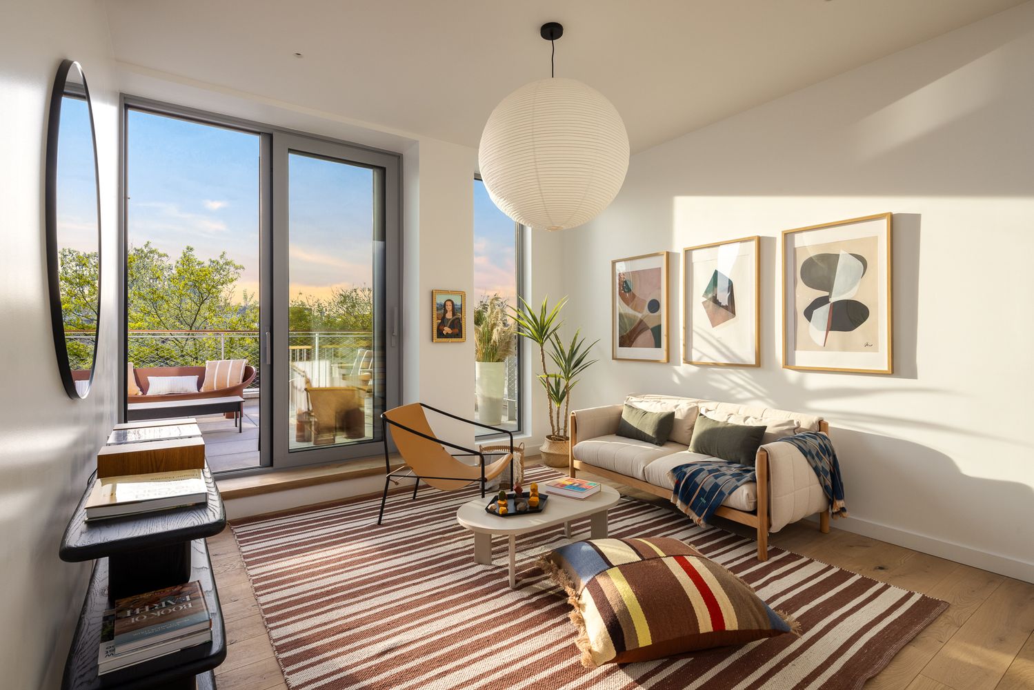 a roof deck with couches and potted plants with sky view