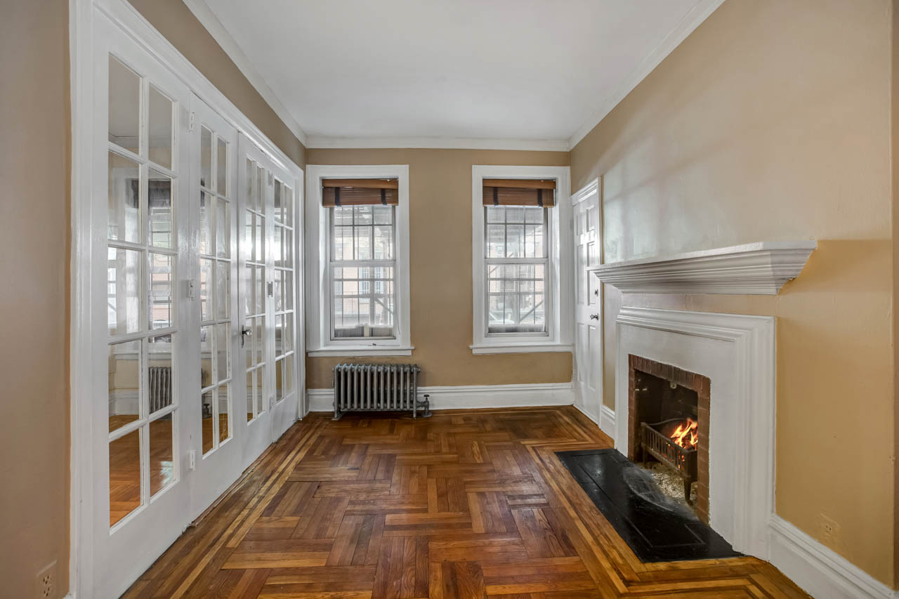 344 West 12th Street, Unit 1A Manhattan, NY 10014 - Photo 7 of 17 a view of a livingroom with wooden floor and a fireplace