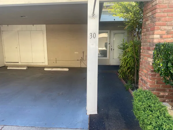 a view of a street with potted plants