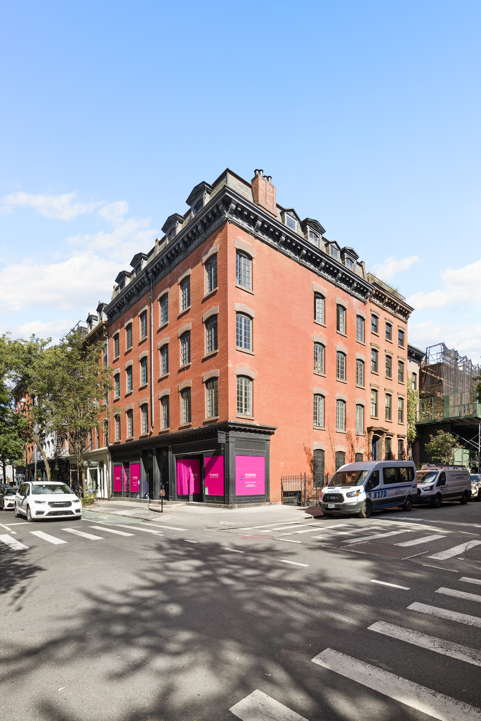 367 Bleecker Street Manhattan, NY 10014 - Photo 10 of 11 a view of building with lot of cars and trees