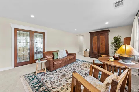 a spacious bedroom with a bed and a dresser