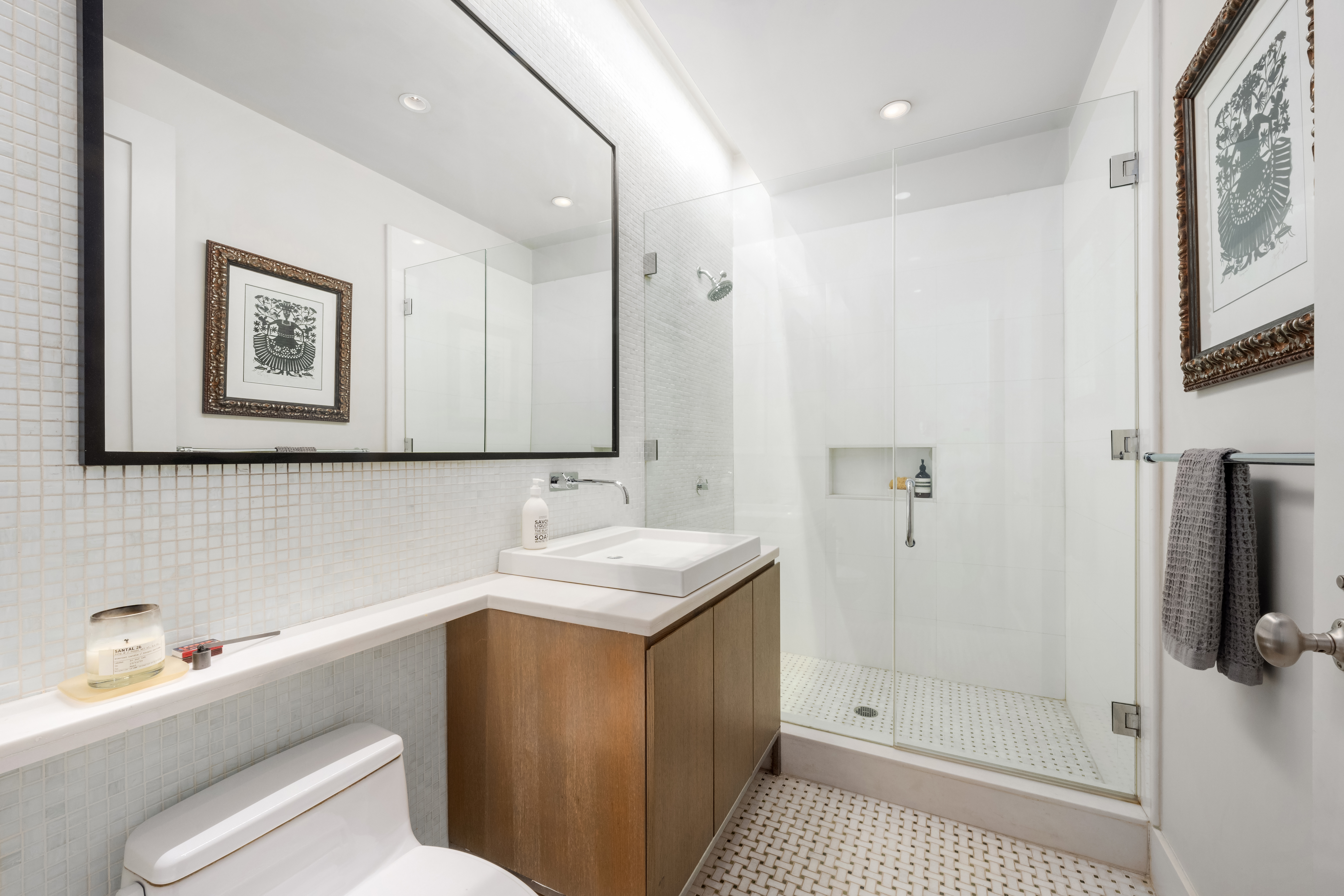 263 9th Avenue, Unit 7E Manhattan, NY 10001 - Photo 12 of 17 a bathroom with a sink a toilet and shower