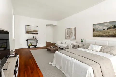 a bedroom with two beds and a desk