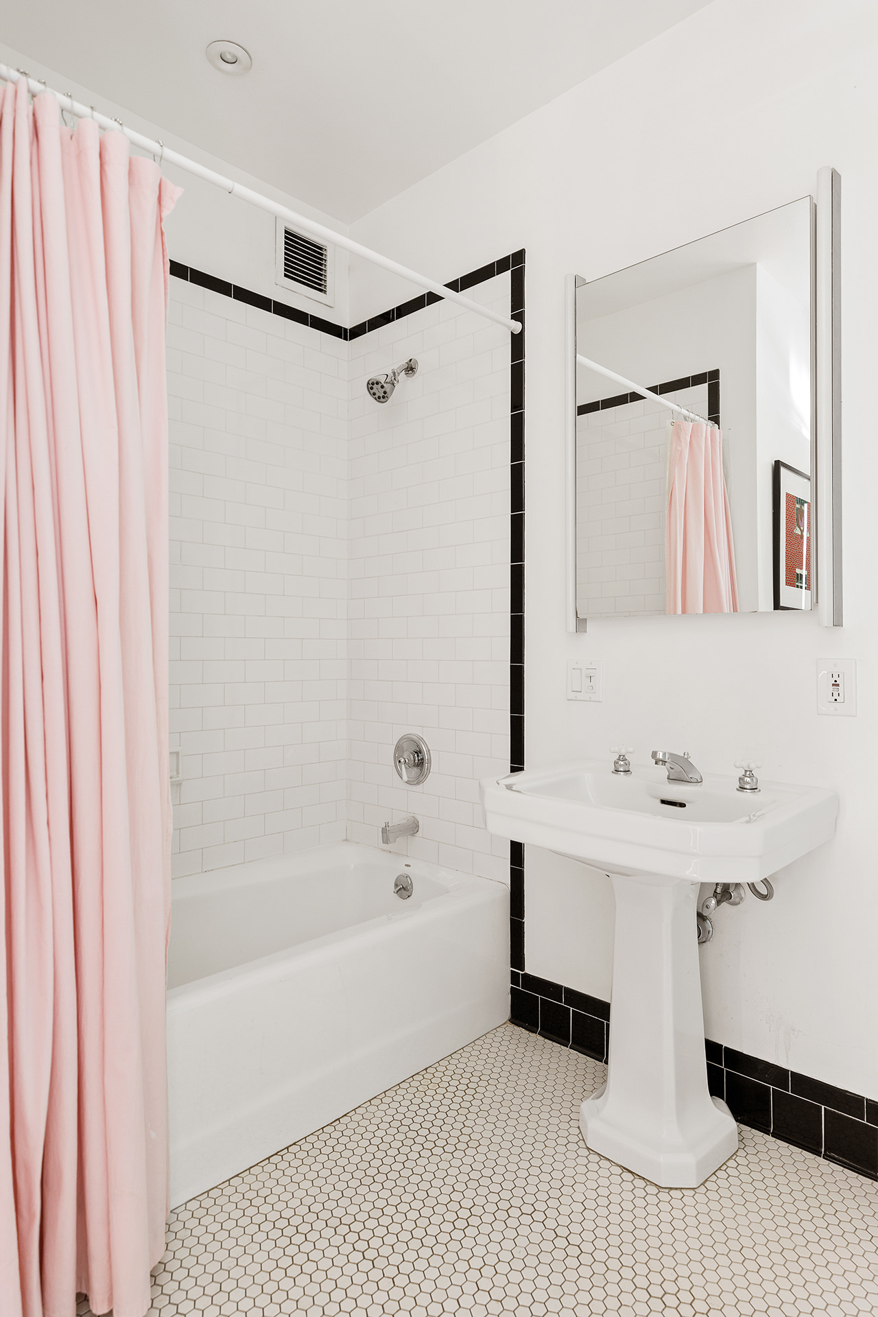 525 West 22nd Street, Unit 3AF Manhattan, NY 10011 - Photo 15 of 25 a bathroom with a sink a mirror and a bathtub