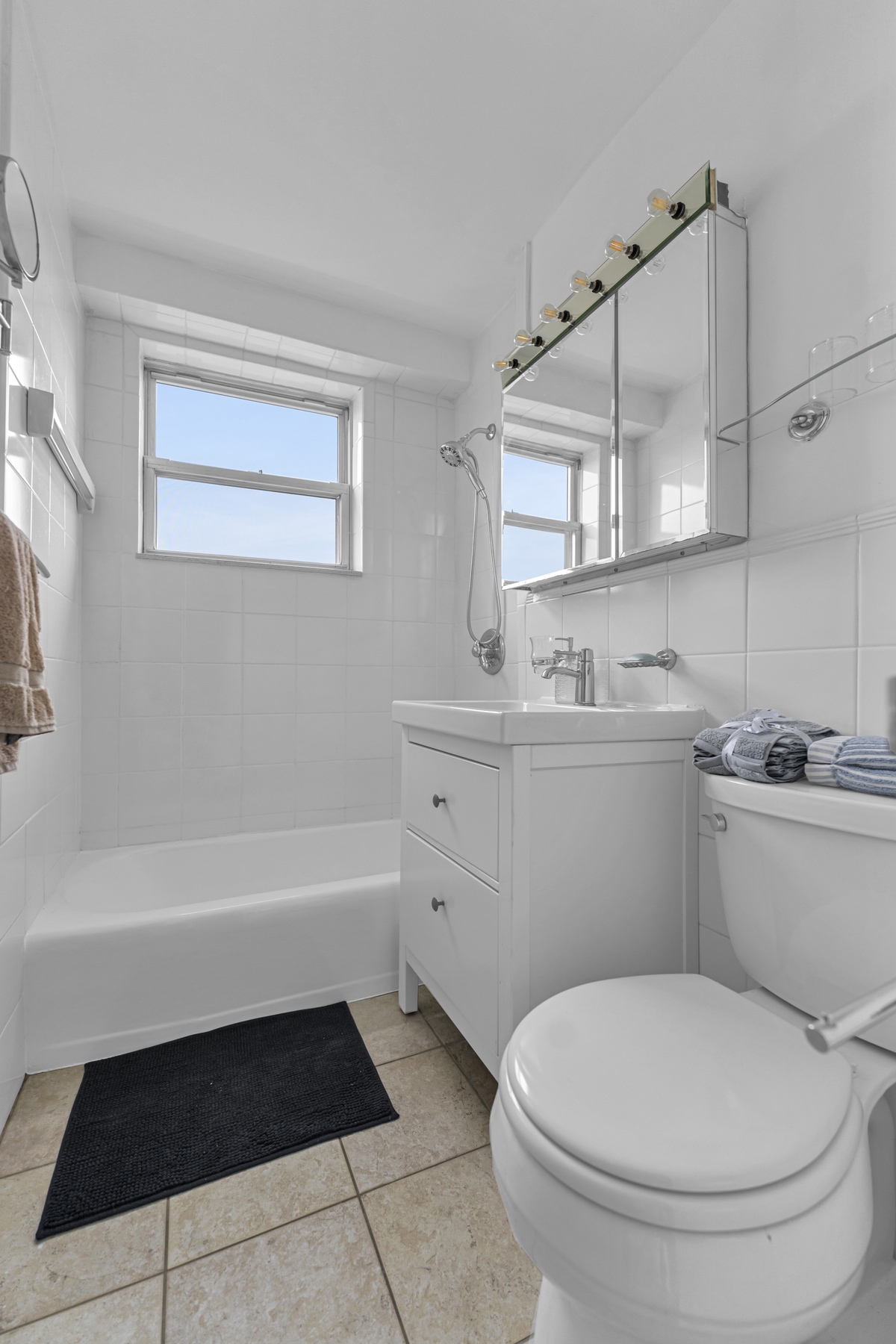 5800 Arlington Avenue, Unit 6V Bronx, NY 10471 - Photo 12 of 15 a bathroom with a sink a toilet and bathtub