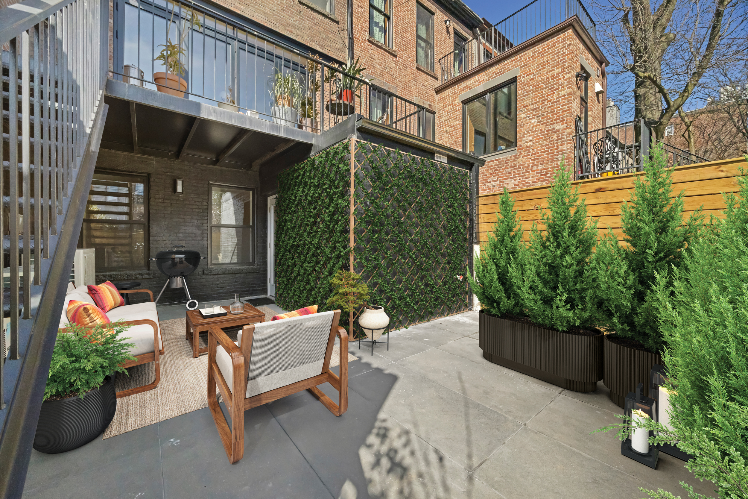 544 Madison Street, Unit A Brooklyn, NY 11221 - Photo 15 of 17 a backyard of a house with outdoor seating