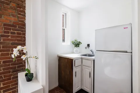 a utility room with cabinets washer and dryer