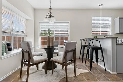 a view of a dining room with furniture window and outside view