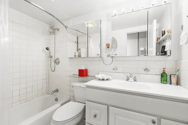 a bathroom with a sink toilet vanity and shower