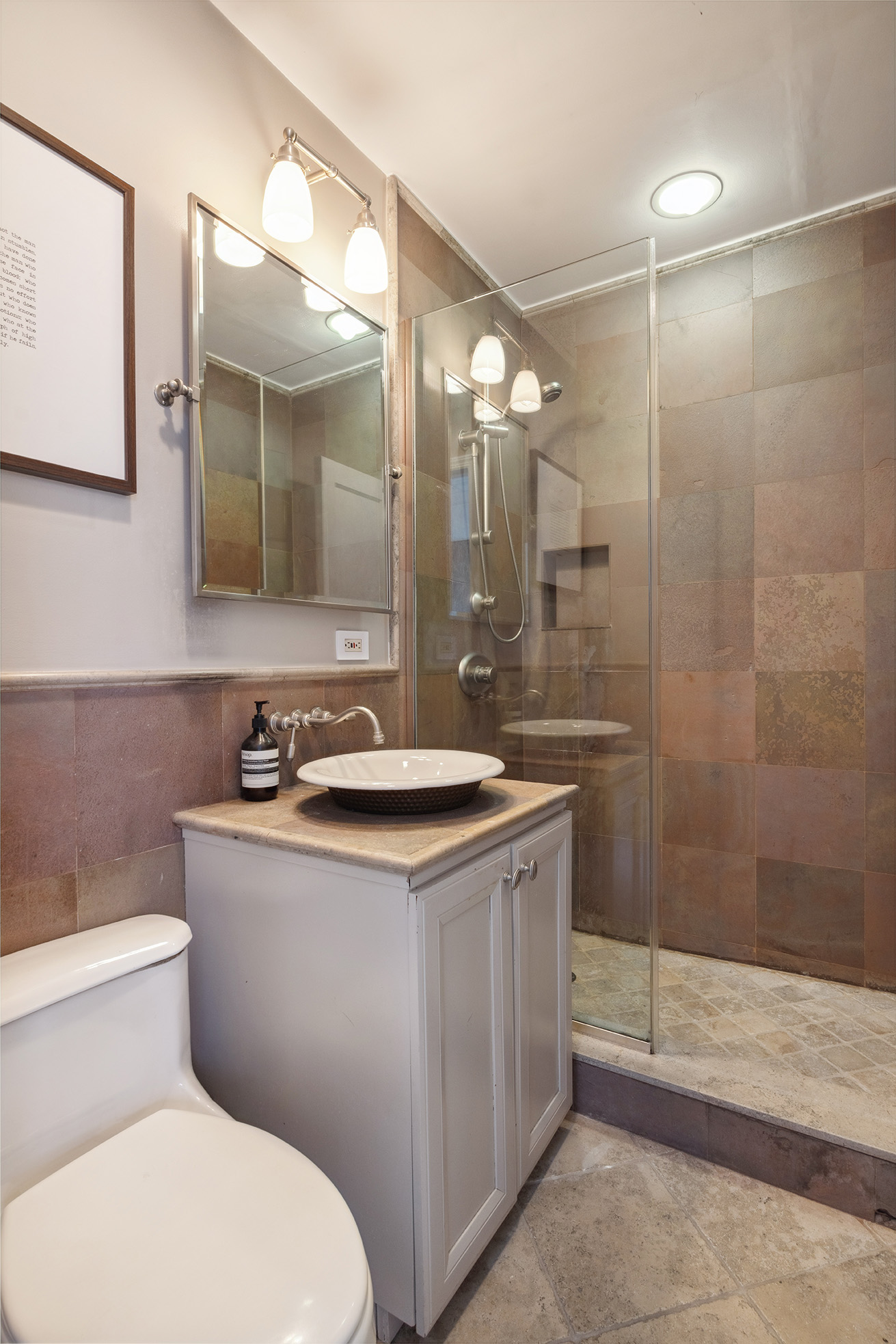 250 Mercer Street, Unit A504 Manhattan, NY 10012 - Photo 8 of 13 a bathroom with a sink a toilet and shower