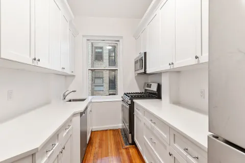 a kitchen with a sink stove and cabinets