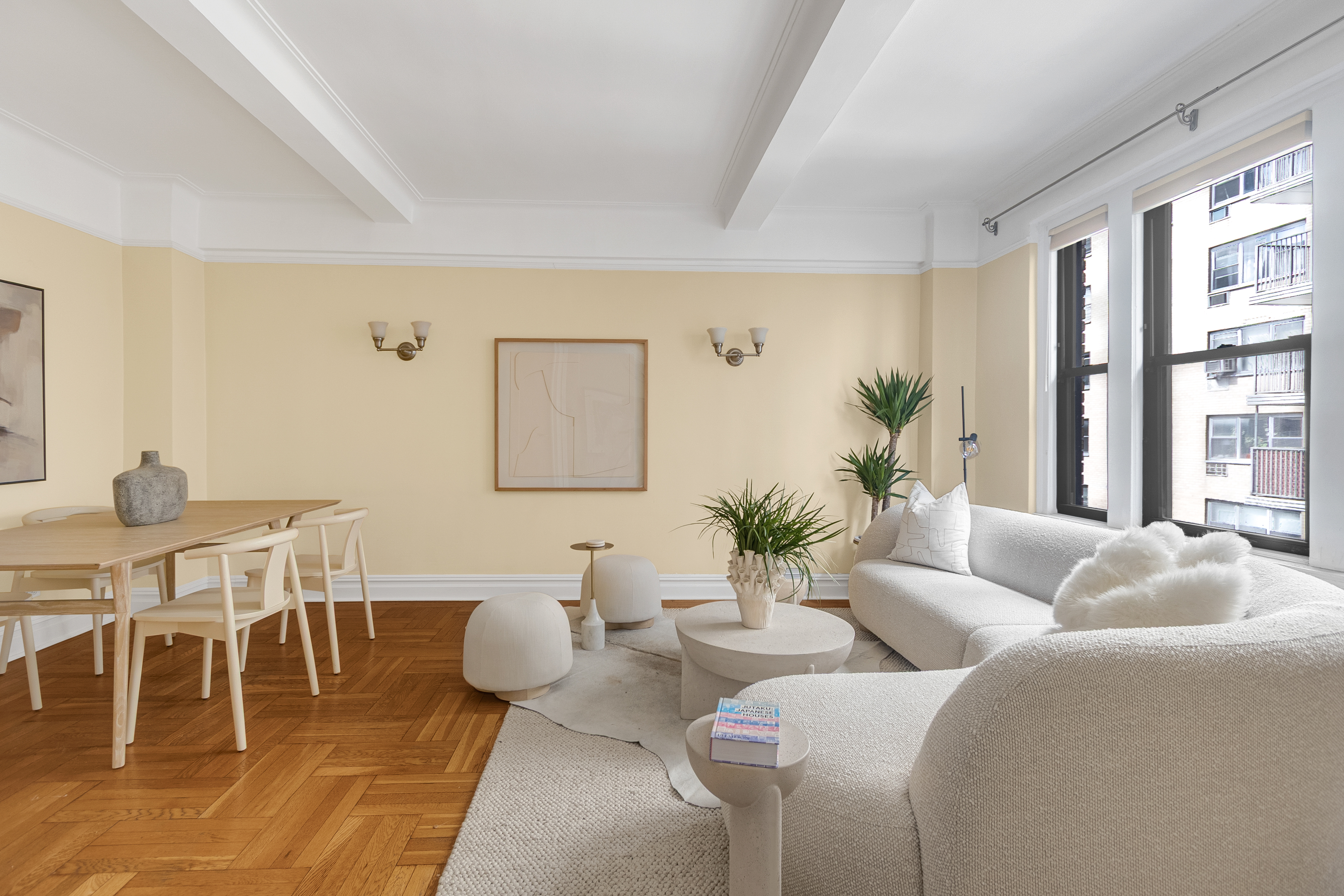a living room with furniture a table and a large window