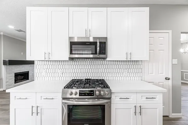 a kitchen with cabinets and appliances