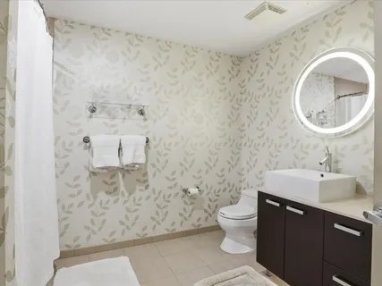 a bathroom with a sink a toilet and mirror