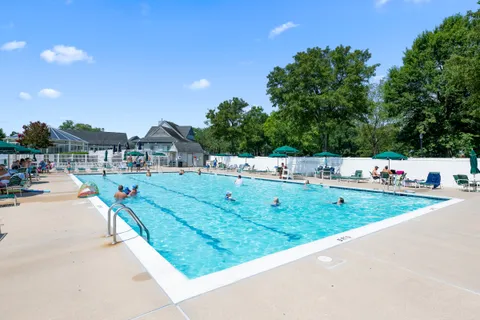 a view of a house with swimming pool and sitting area