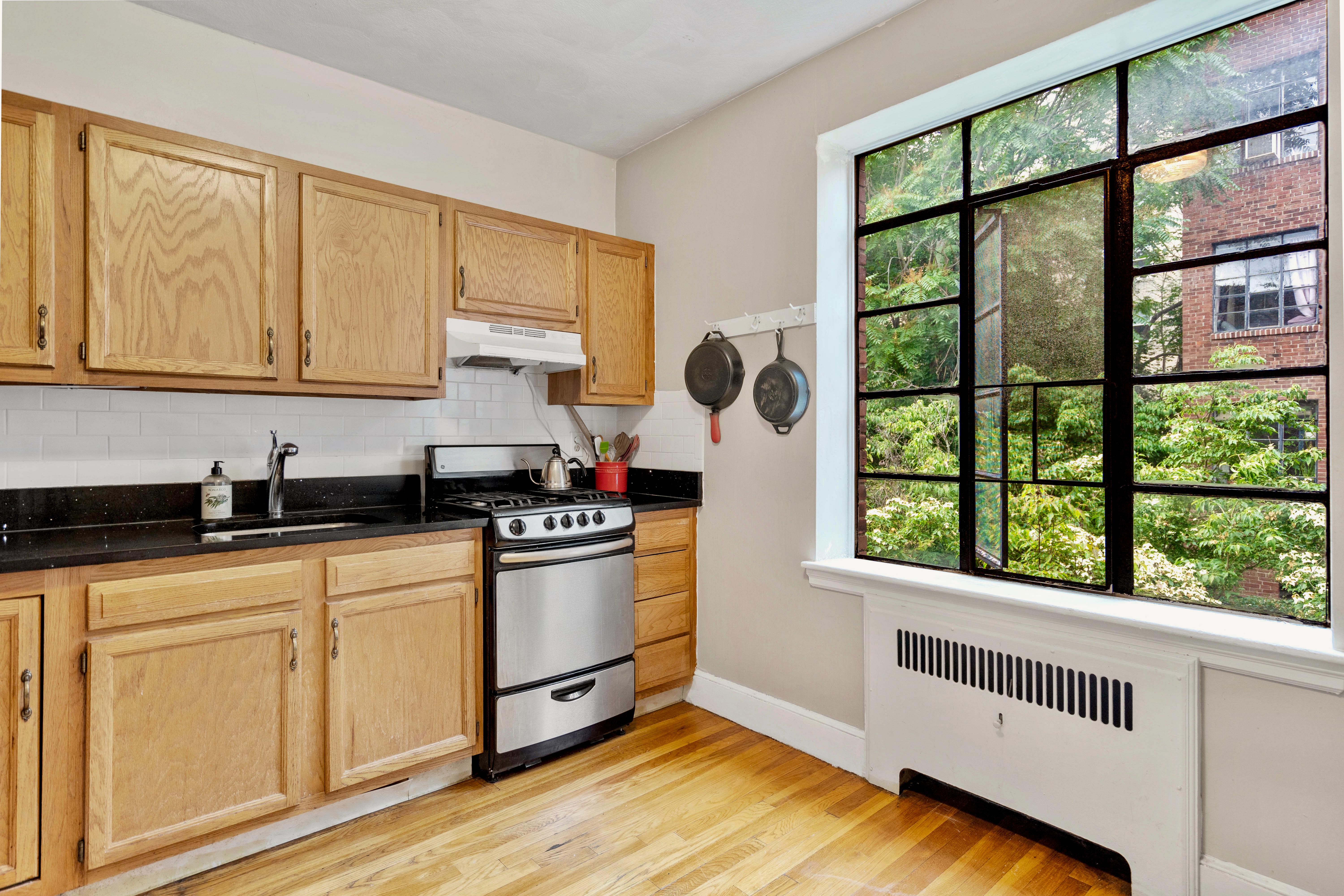 93 Strathmore Road, Unit 8 Brighton, MA 02135 - Photo 3 of 16 a kitchen with stainless steel appliances granite countertop a stove and a white cabinets