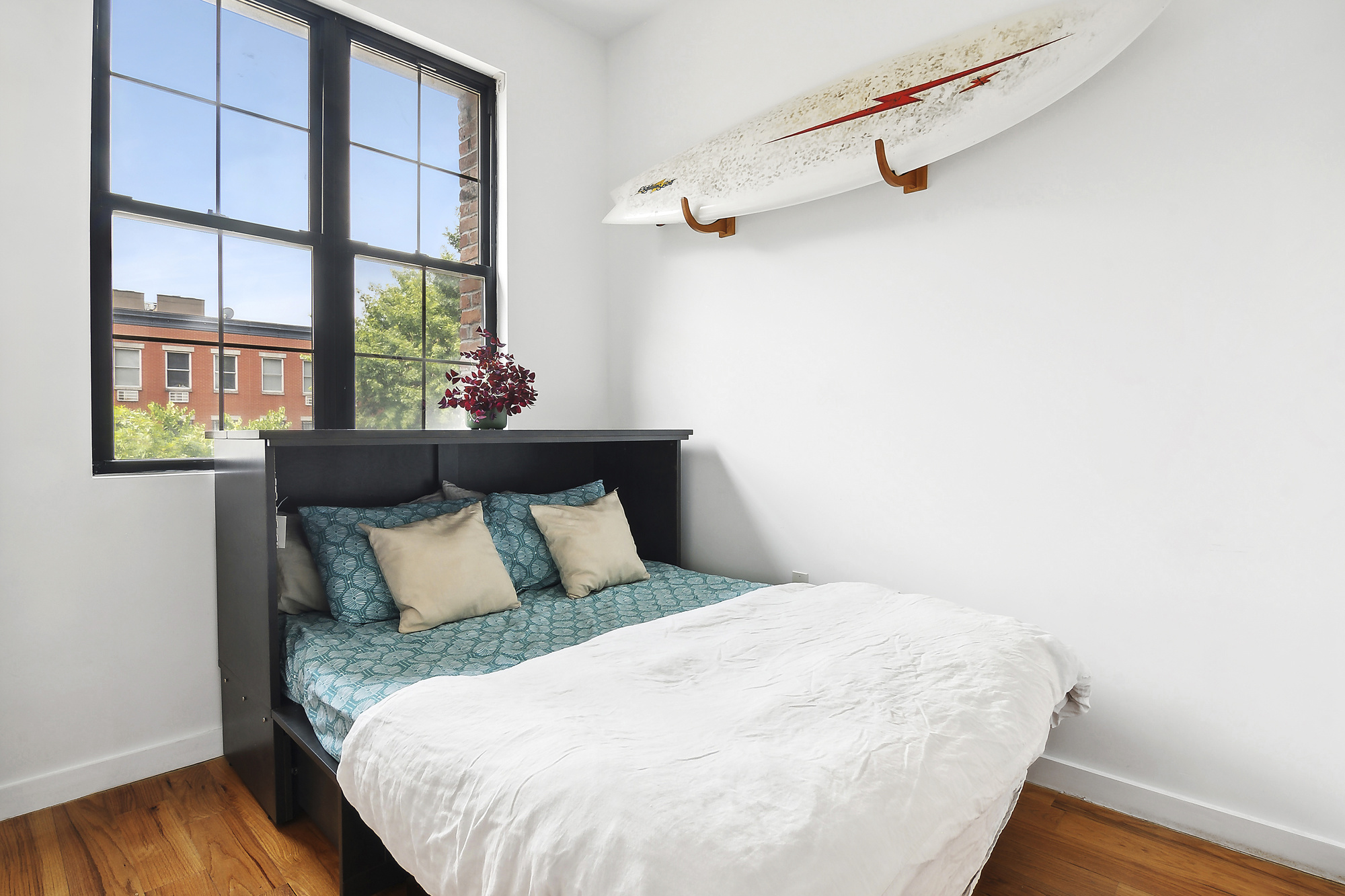 449 Evergreen Avenue, Unit 1 Brooklyn, NY 11221 - Photo 5 of 10 a bed sitting in a bedroom next to a window